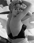 1000JF0208-01
&copy; John French
Model posing in a bustier, photo John French. London, England, 1960